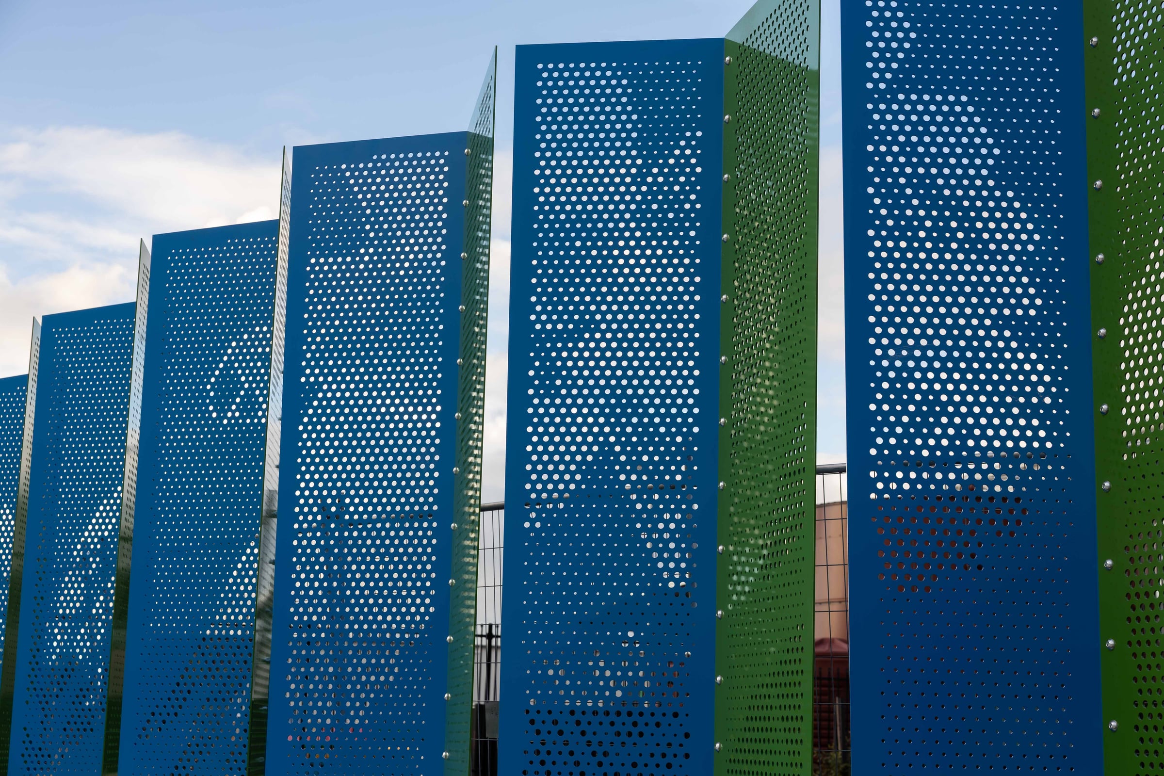 Photographed from below, the two toned steel pleats of Duality alternate against the sky.