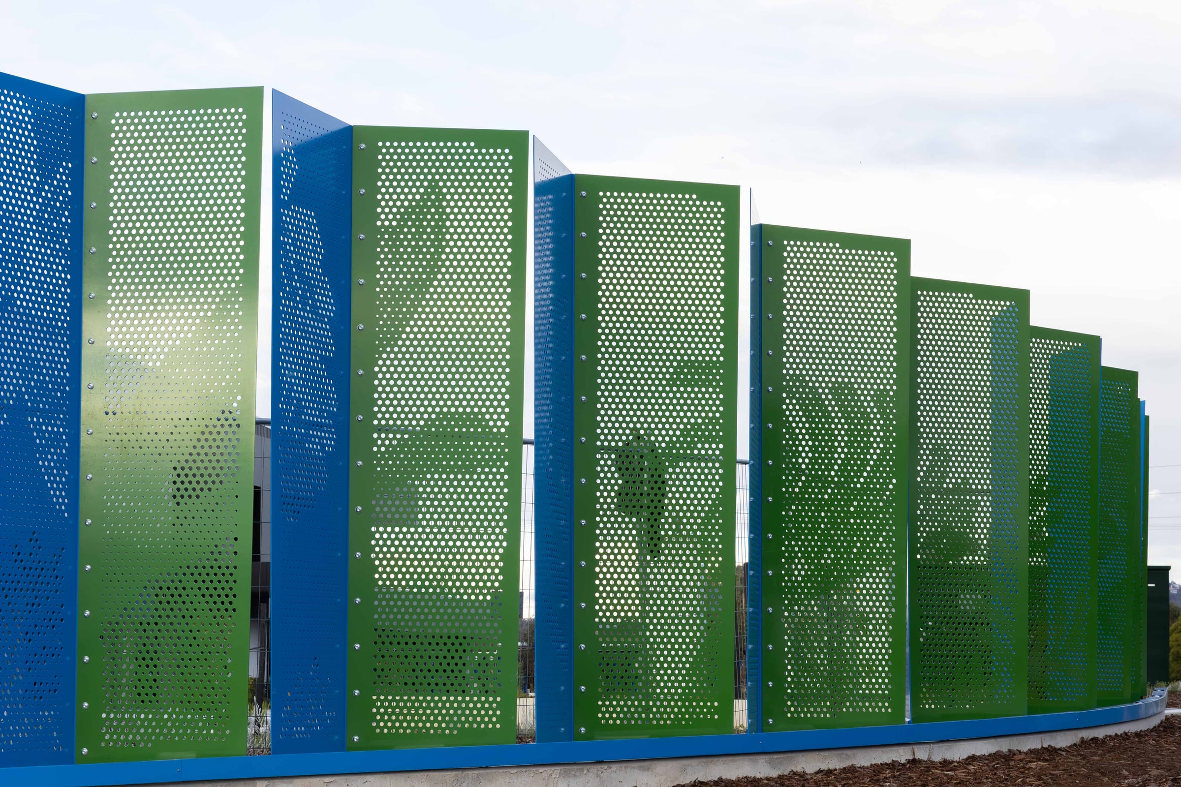 Perforated foliage imagery emerges across the green face of Duality outside the Hazelmere warehouse.
