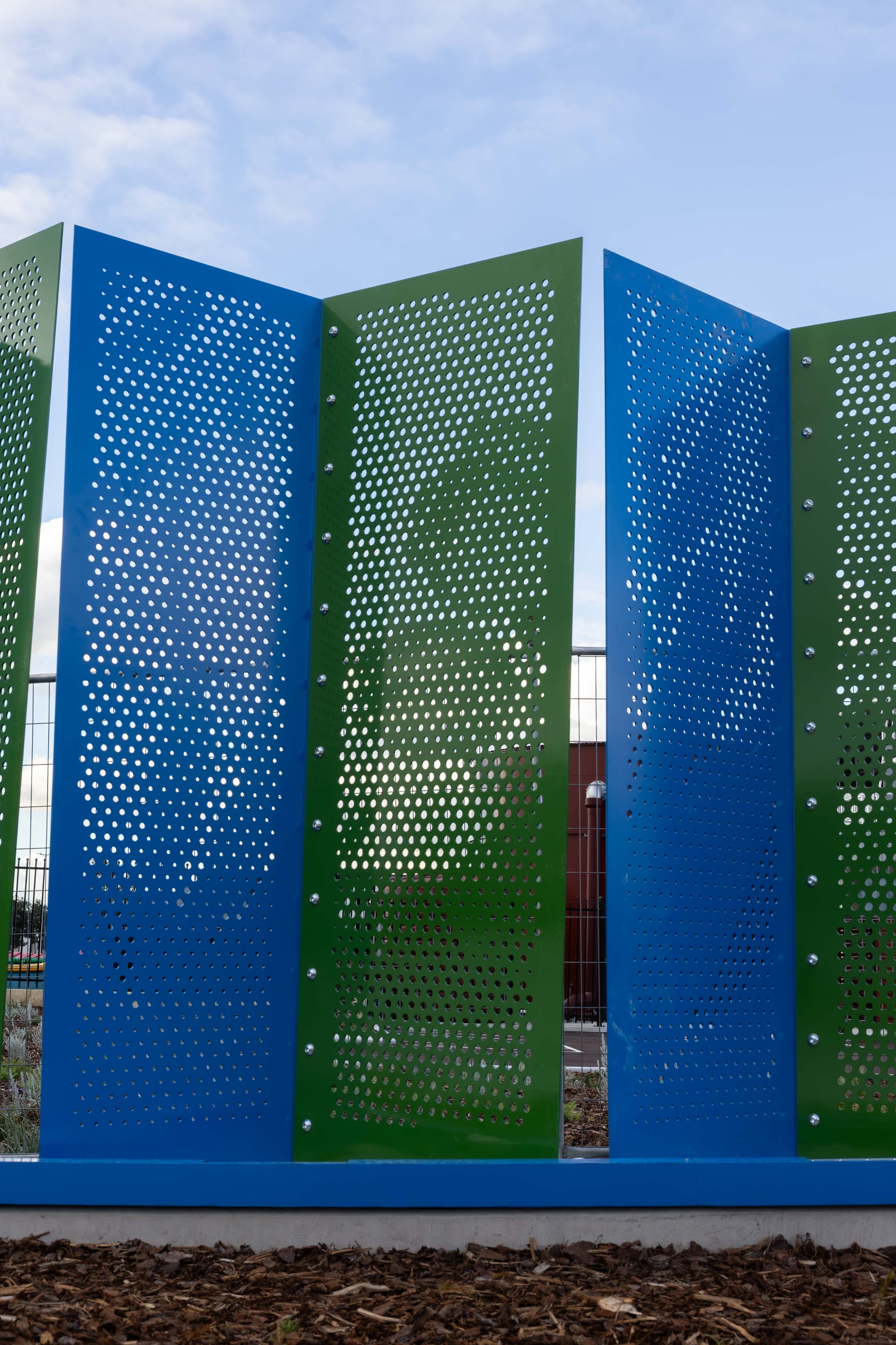 Alternating blue and green pleats of Duality rise against a clear Hazelmere sky.