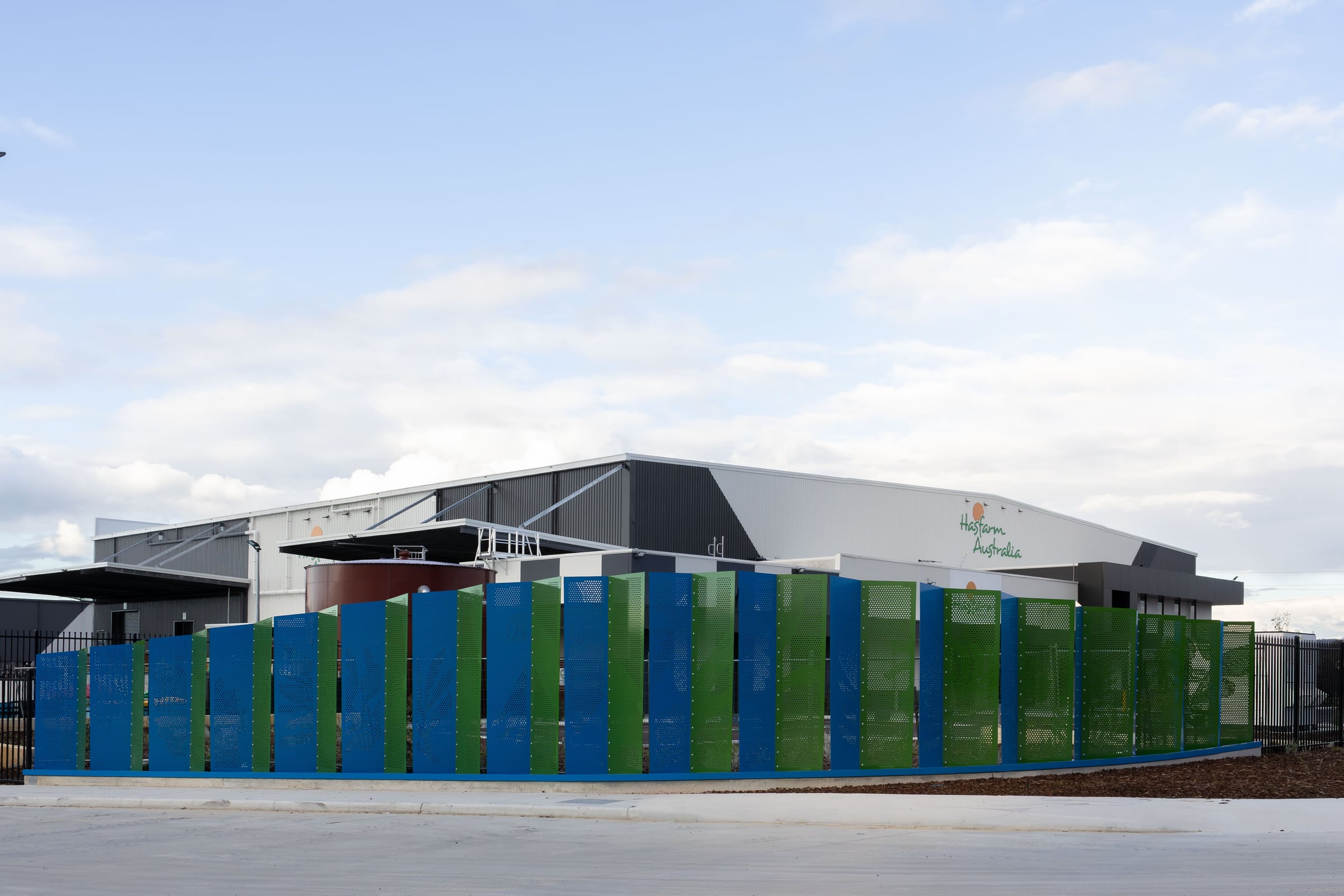 The completed entry statement runs along Adelaide St, its perforated panels alternating blue and green.