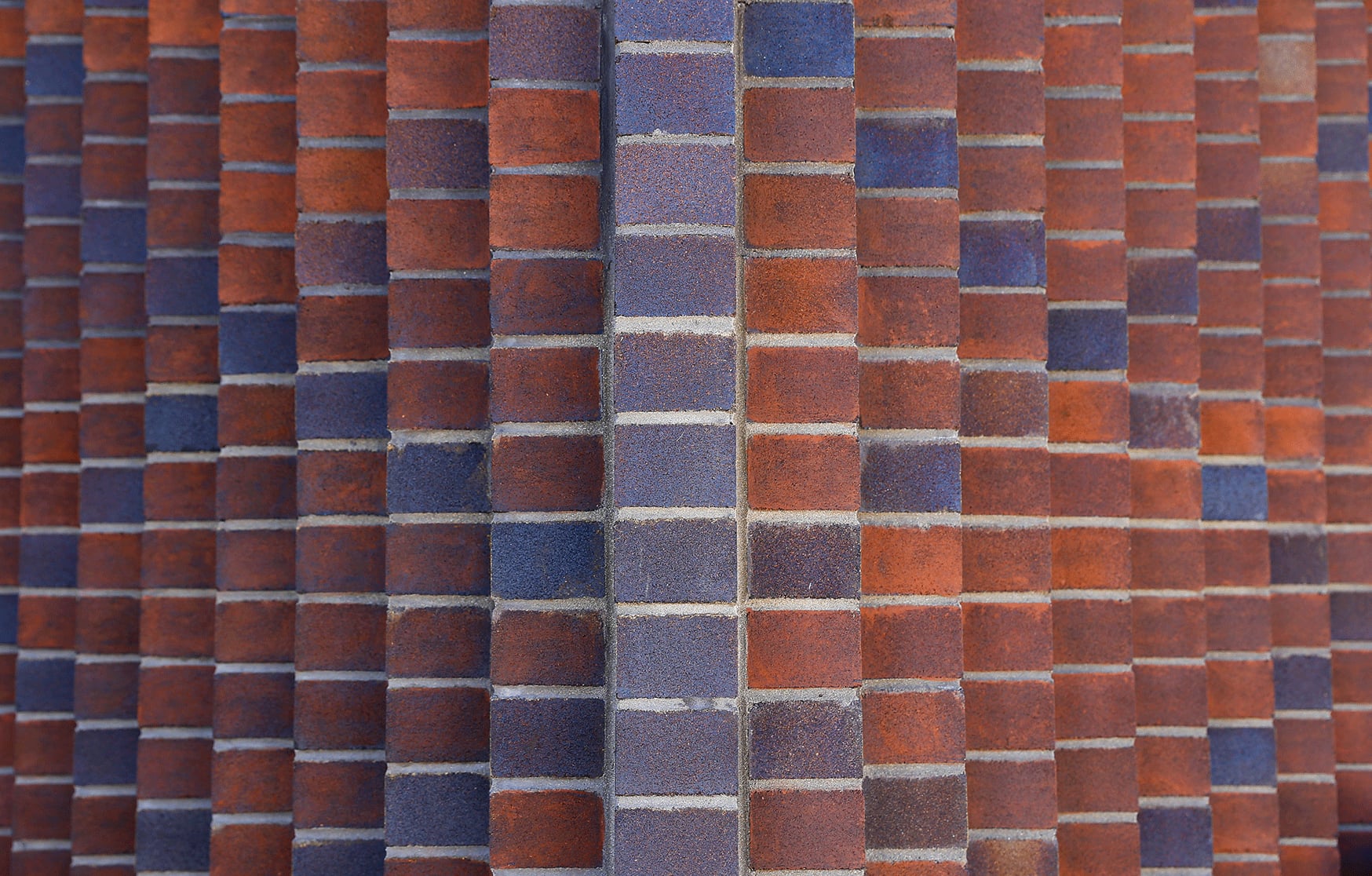 Detail of the projecting red and blue brick columns that form the Queenslea lenticular wall in Claremont.