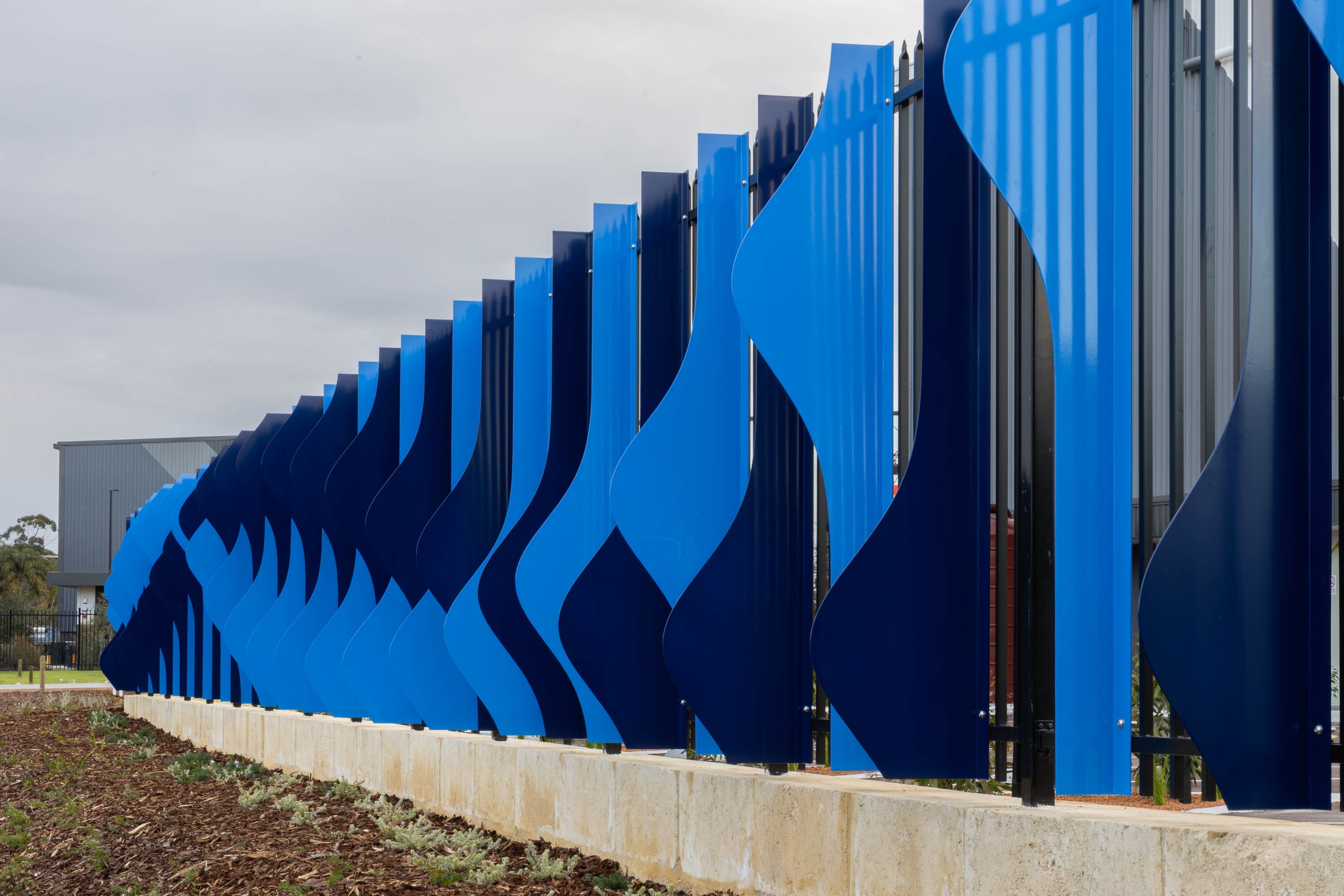 Close perspective along the twisting blue powdercoated fins of the Cascading Creeks stage in Hazelmere.