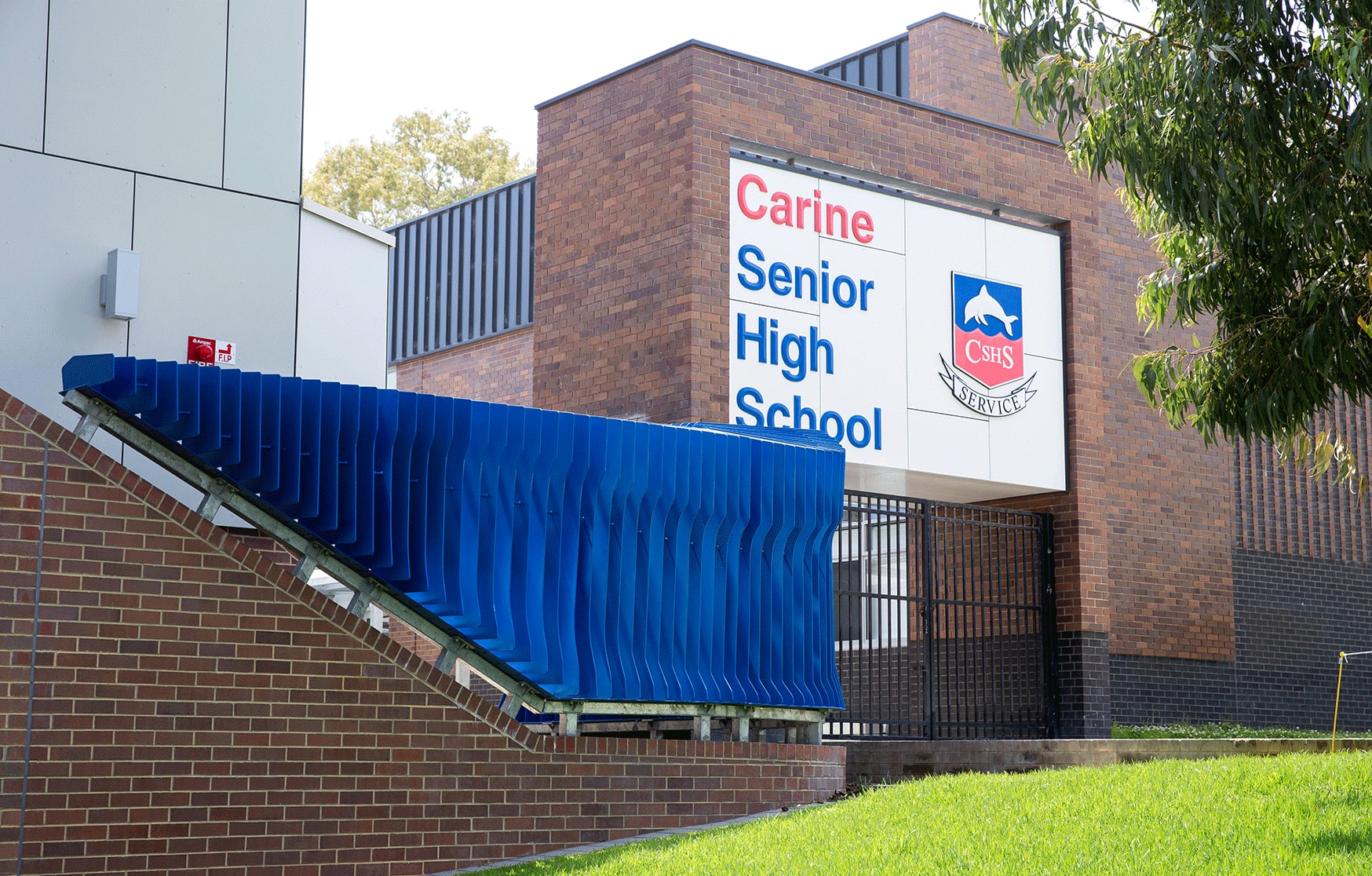 The Exchange steps down a brick wall beside the Carine Senior High School entry signage.