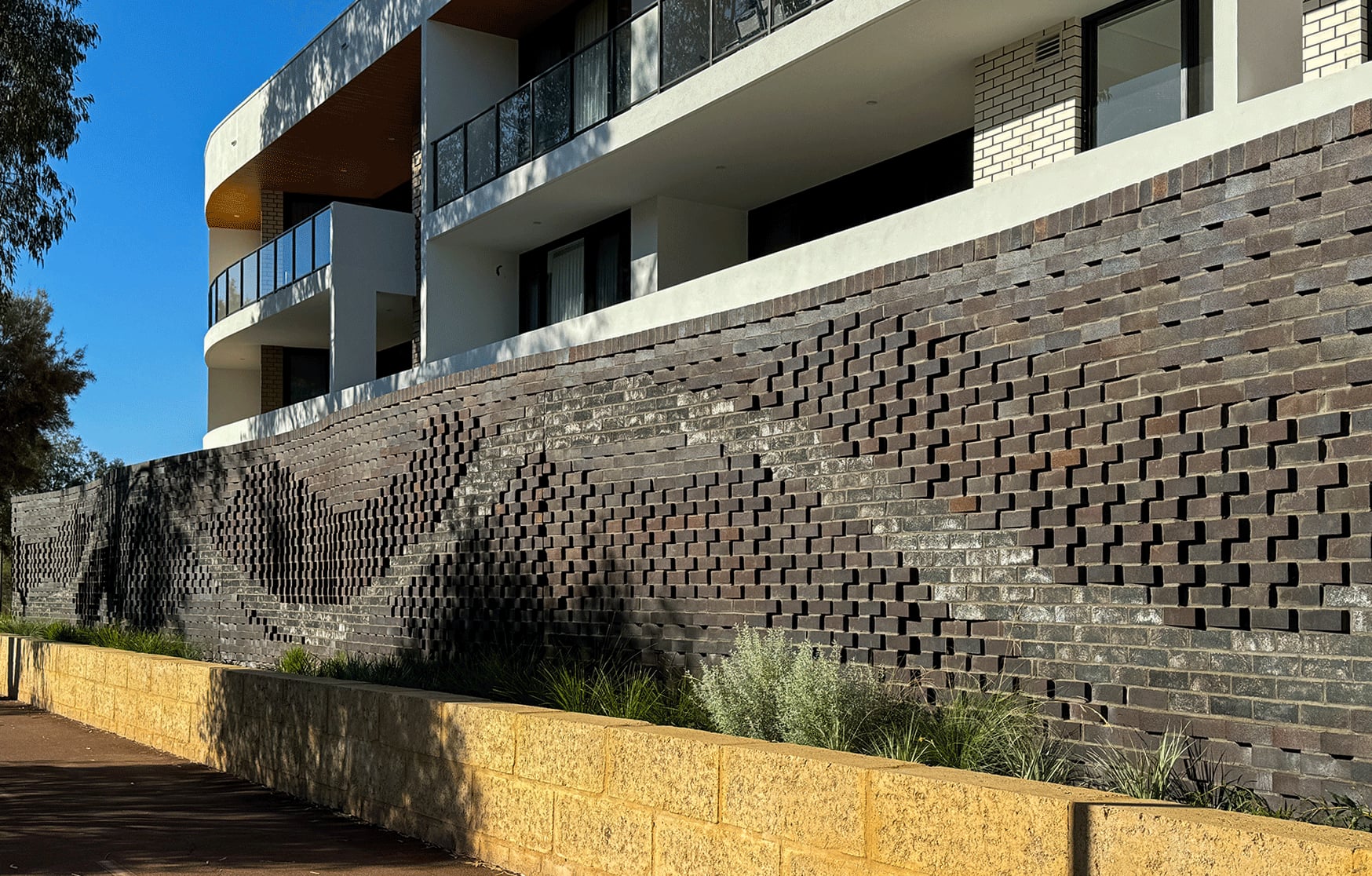 Some 6500 bricks in two tones billow along the integrated Waterford artwork at Cygnia Cove.